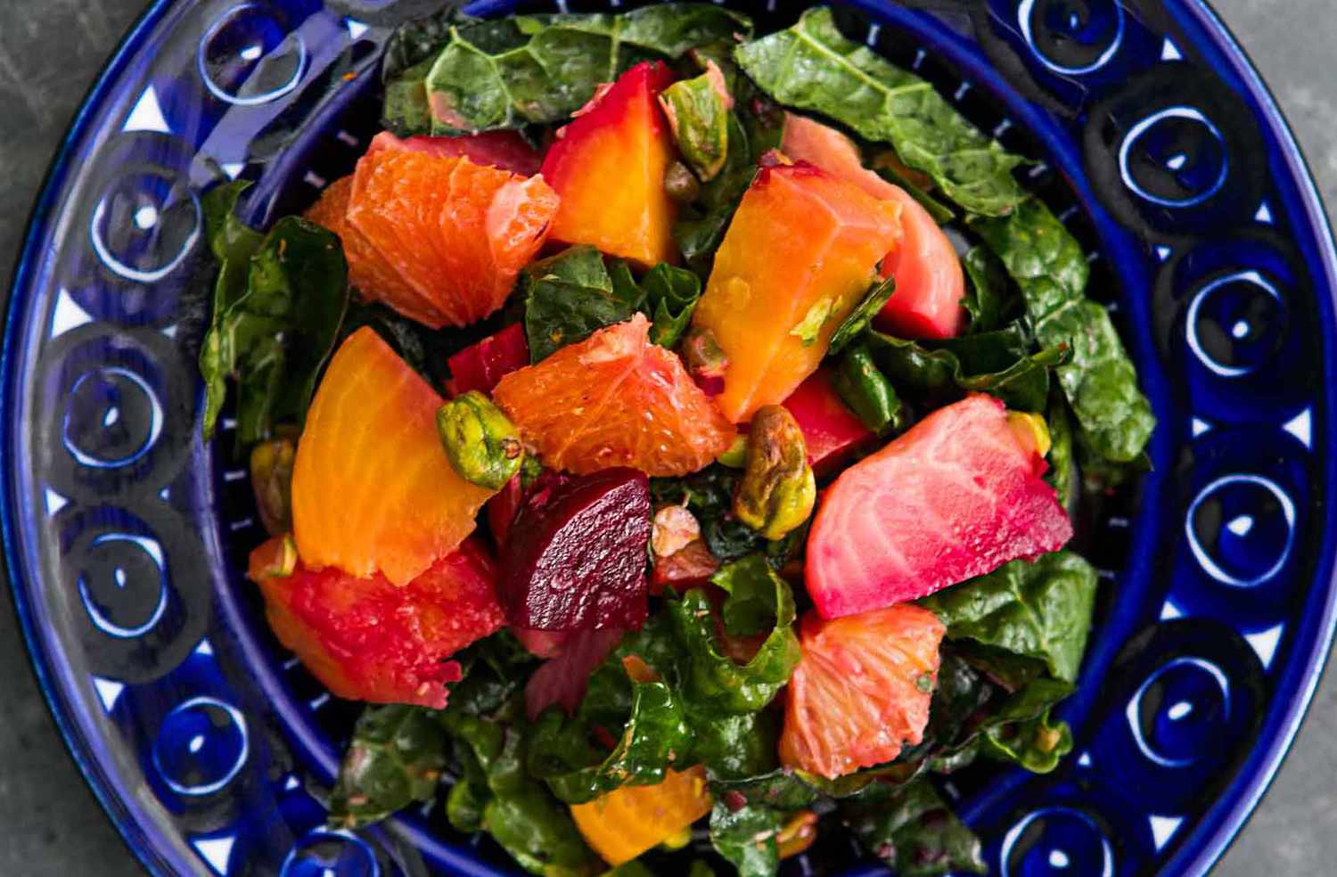 beet and kale salad in a blue bowl