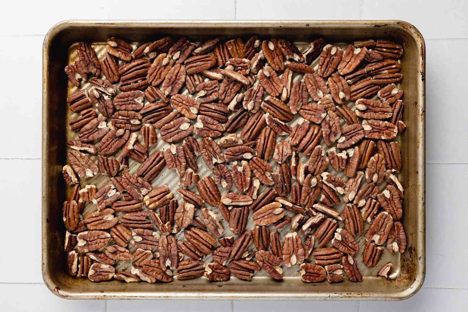 Toasted Pecan Halves in a Baking Tray for Turtle Cookie Cup Recipe
