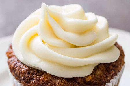 Cream cheese frosting piped on a cupcake