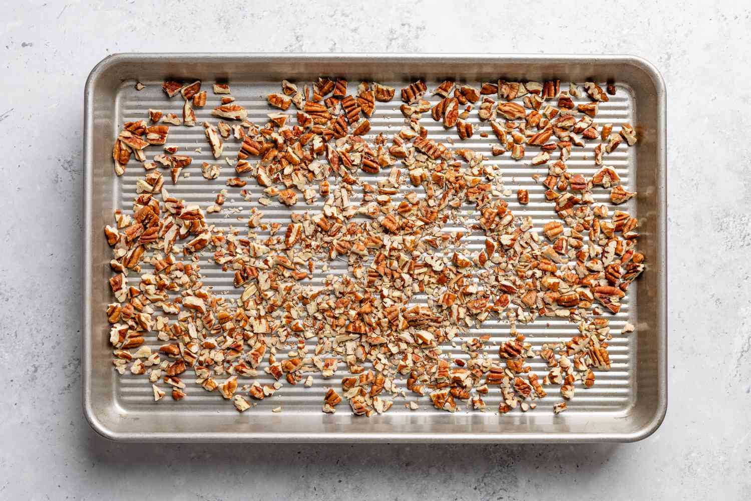 pecans toasted in a baking pan for soda cracker pie recipe