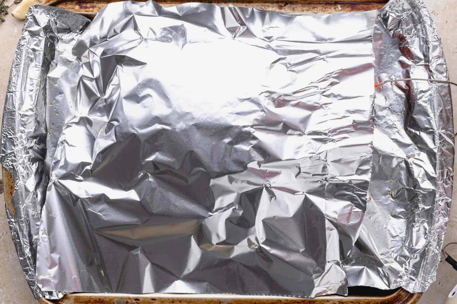 Method shot - Rack of lamb covered in aluminum foil 