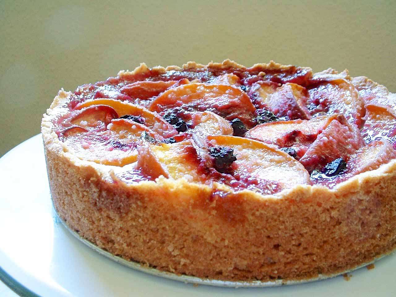 A peach and blueberry cake ready to slice and serve
