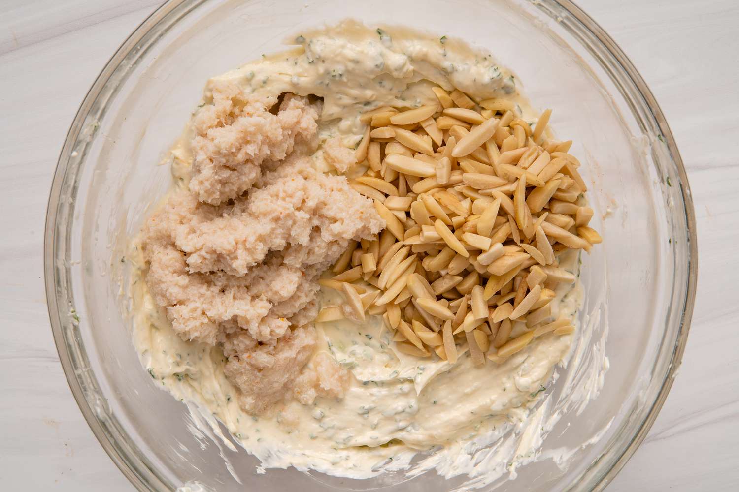 How to make crab dip by mixing ingredients in a glass bowl.