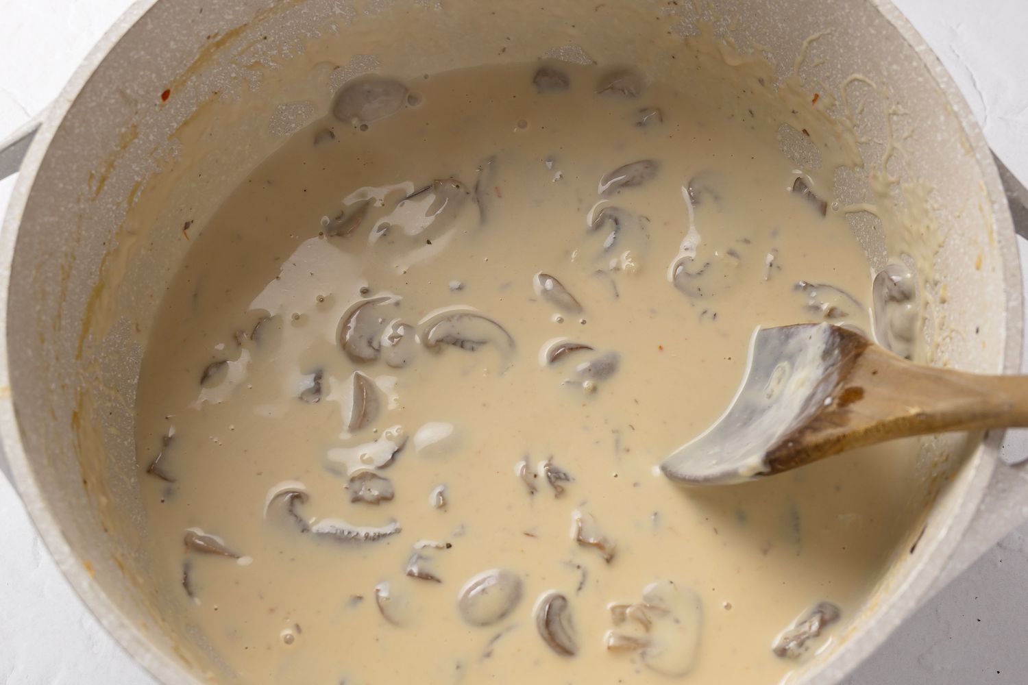 Mushroom Sauce Stirred in a Pot for Slow Cooker Green Bean Casserole Recipe