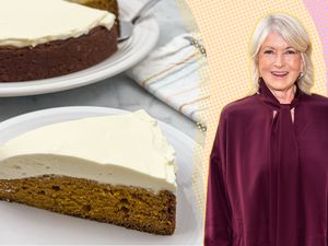 Martha Stewart beside a frosted pumpkin cake slice on a plate