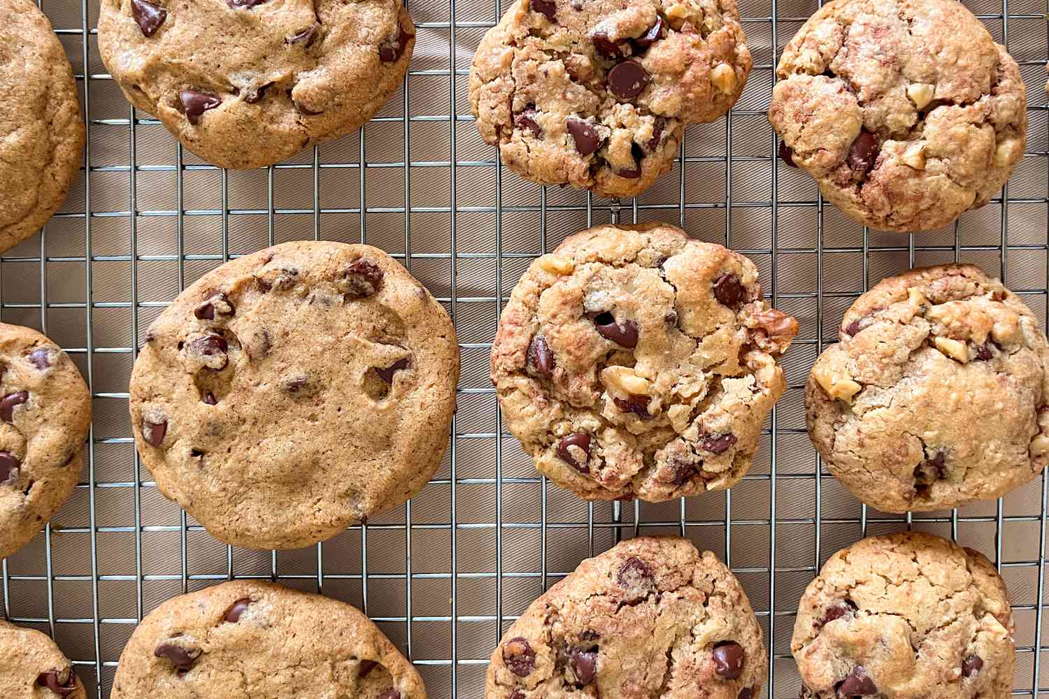 Twelve Neiman Marcus chocolate chip cookies sitting on a wire rack. 