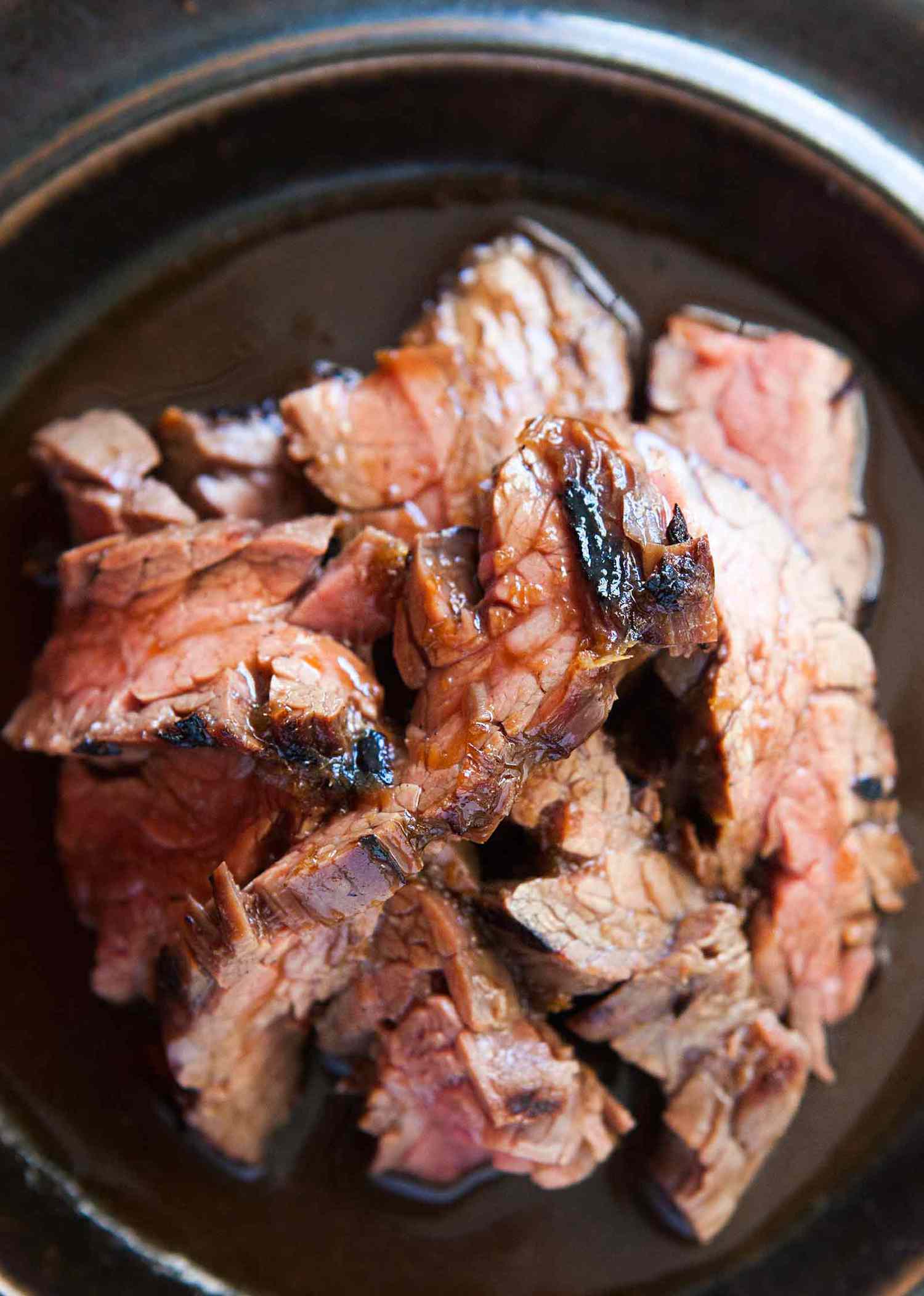 Cooked teriyaki steak strips in a serving bowl
