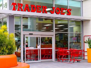 Trader Joe's store entrance with shopping carts outside, glass facade