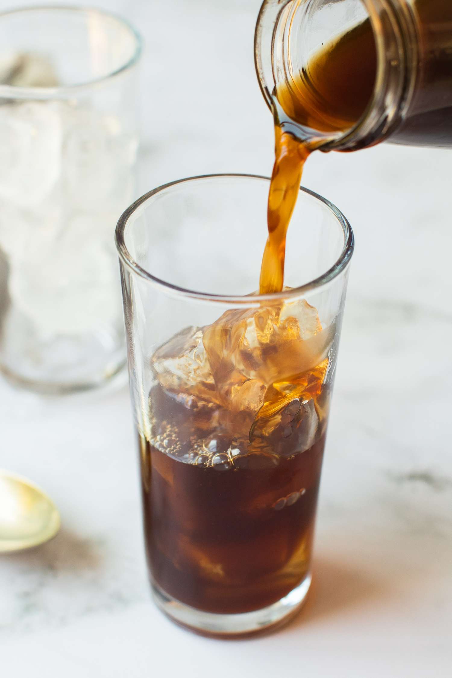 Cold Brew Coffee being poured into a glass with ice