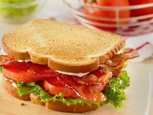 A BLT sandwich with bacon lettuce and tomato on toasted bread
