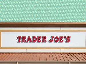 The sign of a Trader Joe's store featuring bold, red lettering on a white background