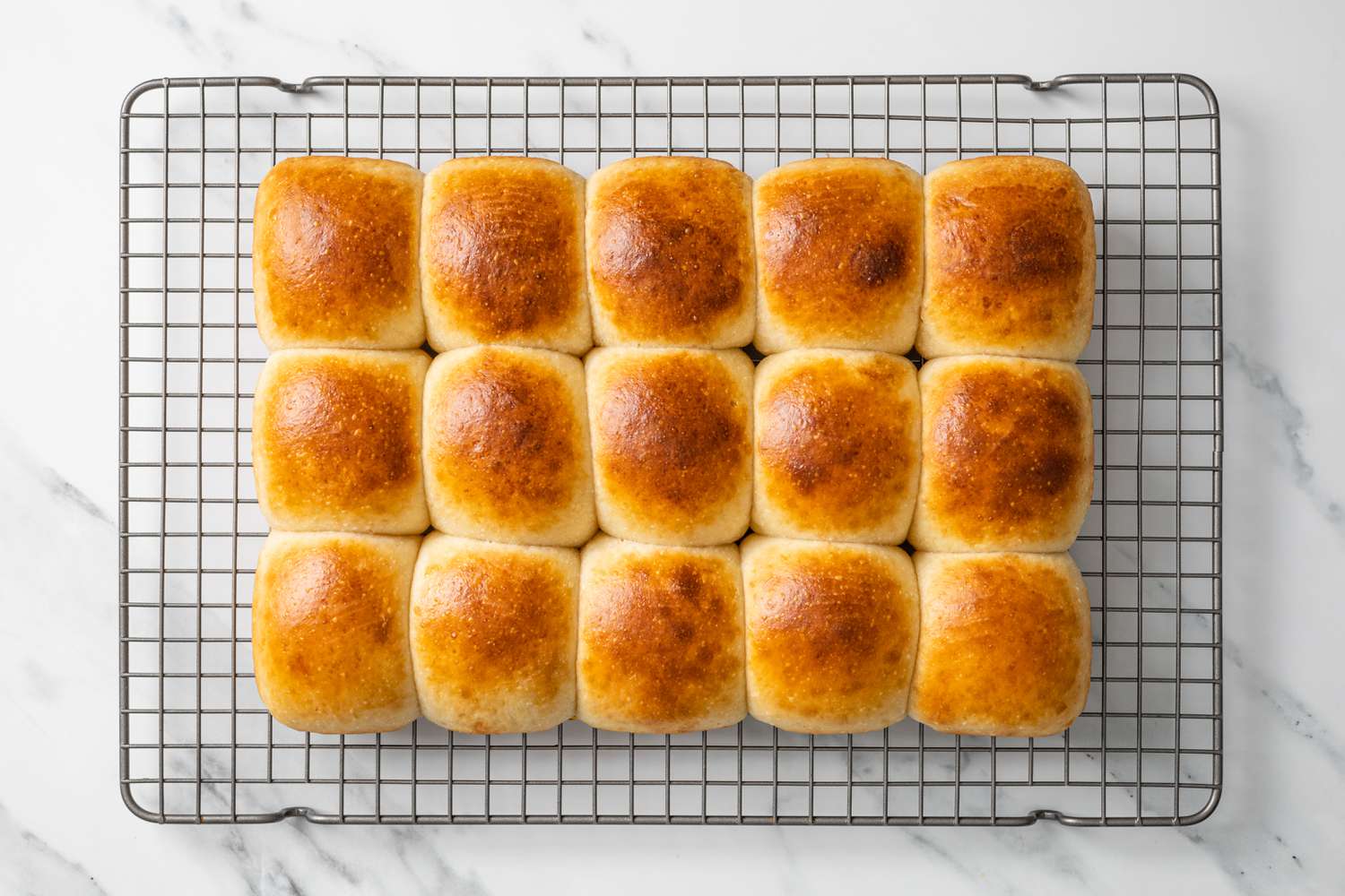 Baked Sourdough Rolls Resting on Cooling Rack