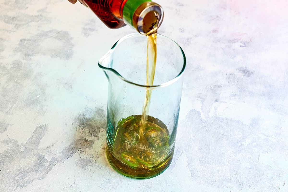 Pouring tequila into a measuring glass