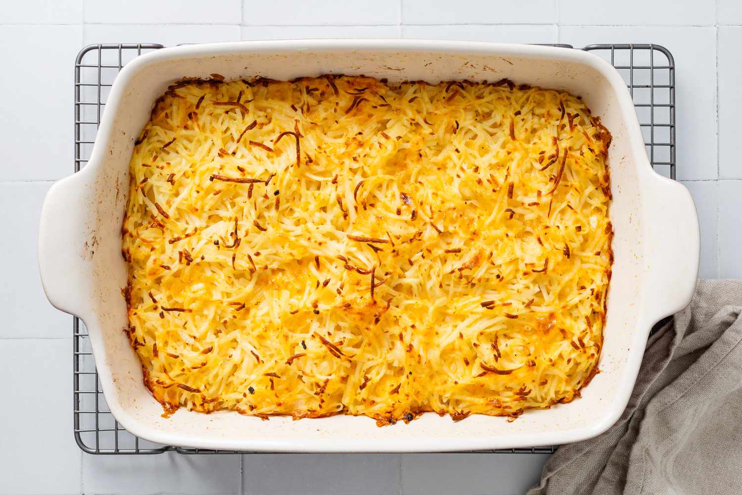 Baked copycat Cracker Barrel hash brown casserole resting on a wire rack