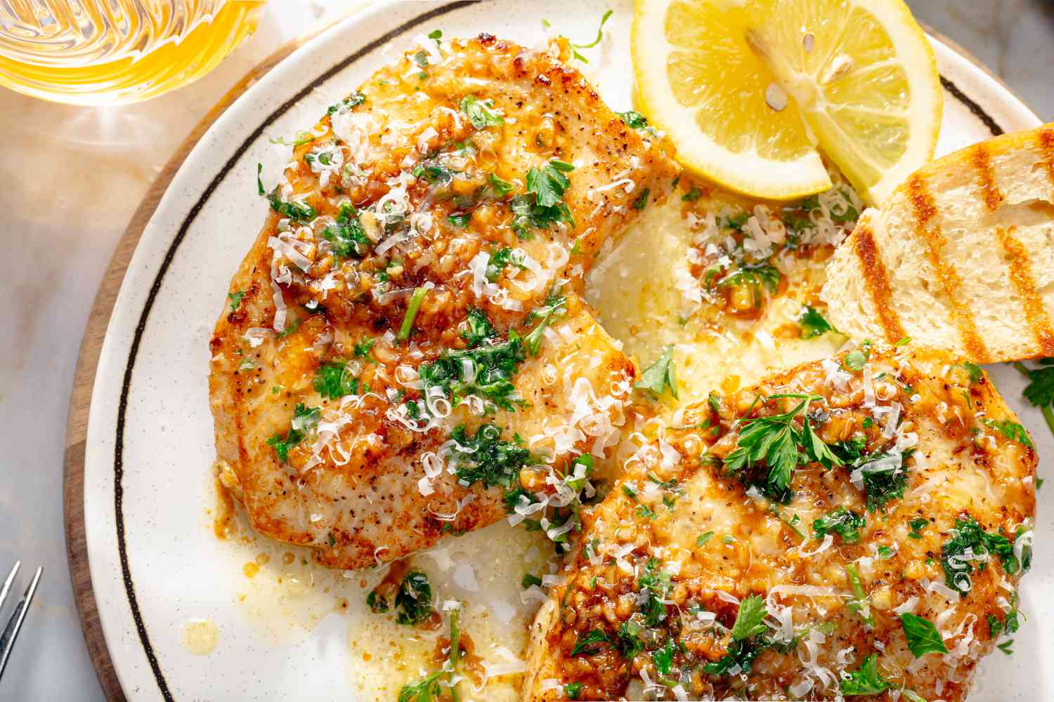 close up of Garlic Knot Chicken Breasts garnished with lemon wedges