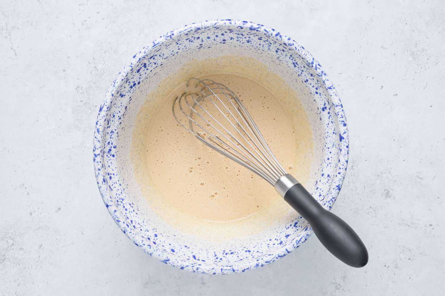 Sugar, eggs, and vanilla whisked together in a bowl