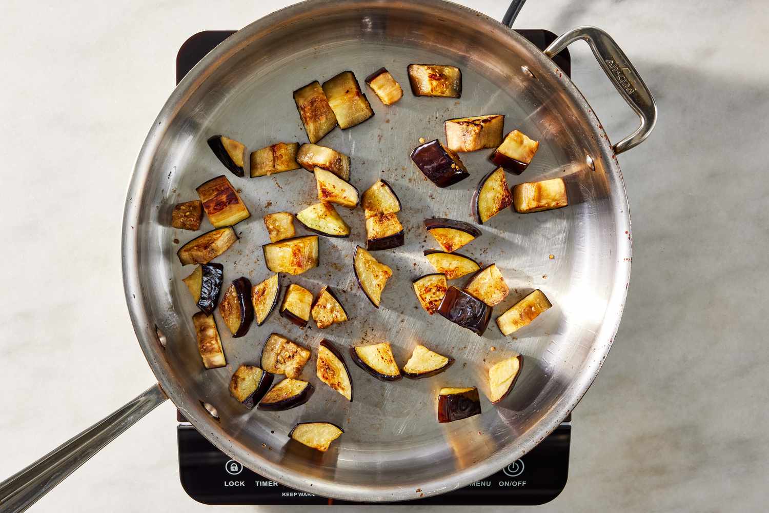 cooked eggplant pieces in a pot for pasta alla norma recipe