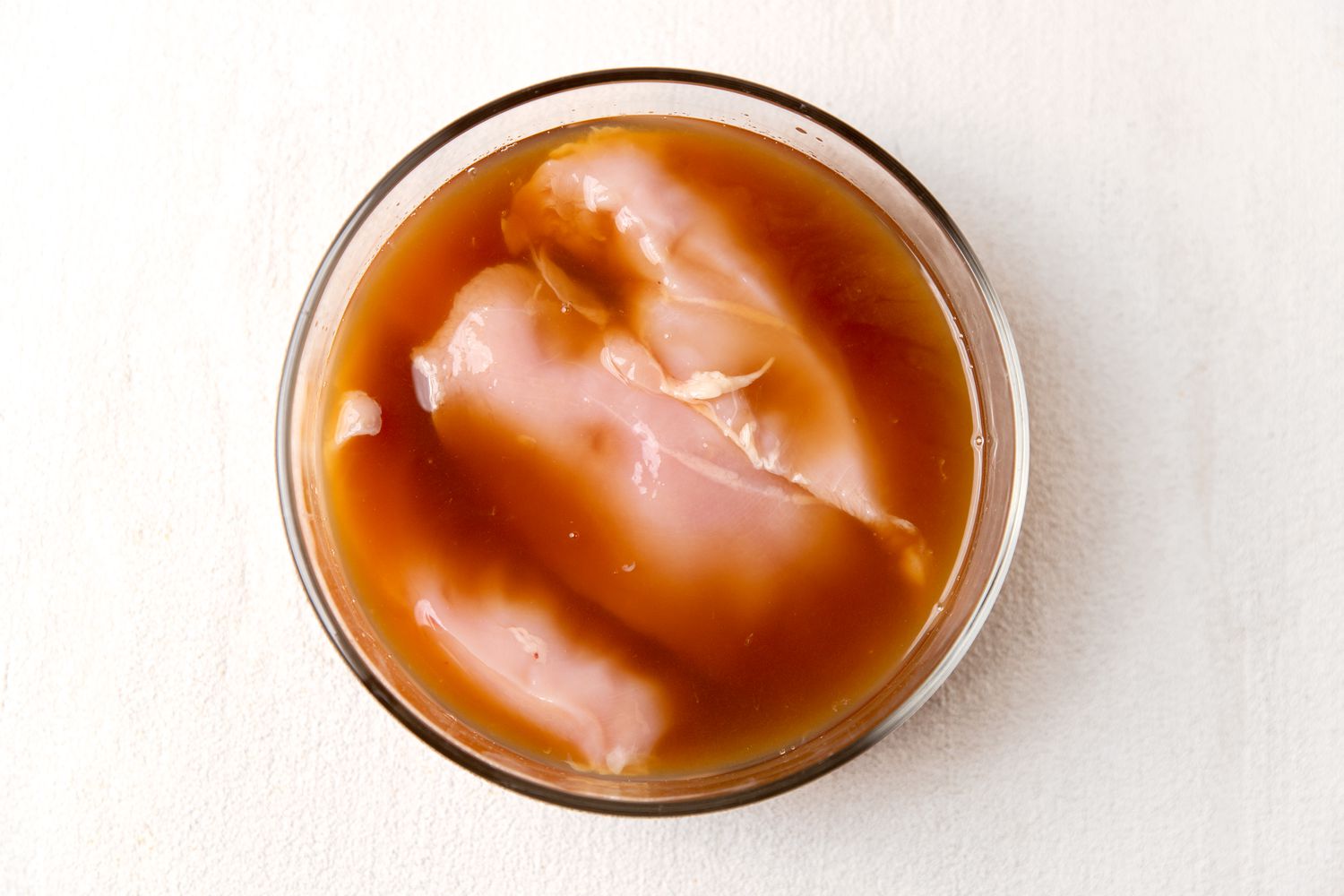 chicken marinating in sherry and lemon juice for Italian butter chicken (petti di pollo al burro) recipe
