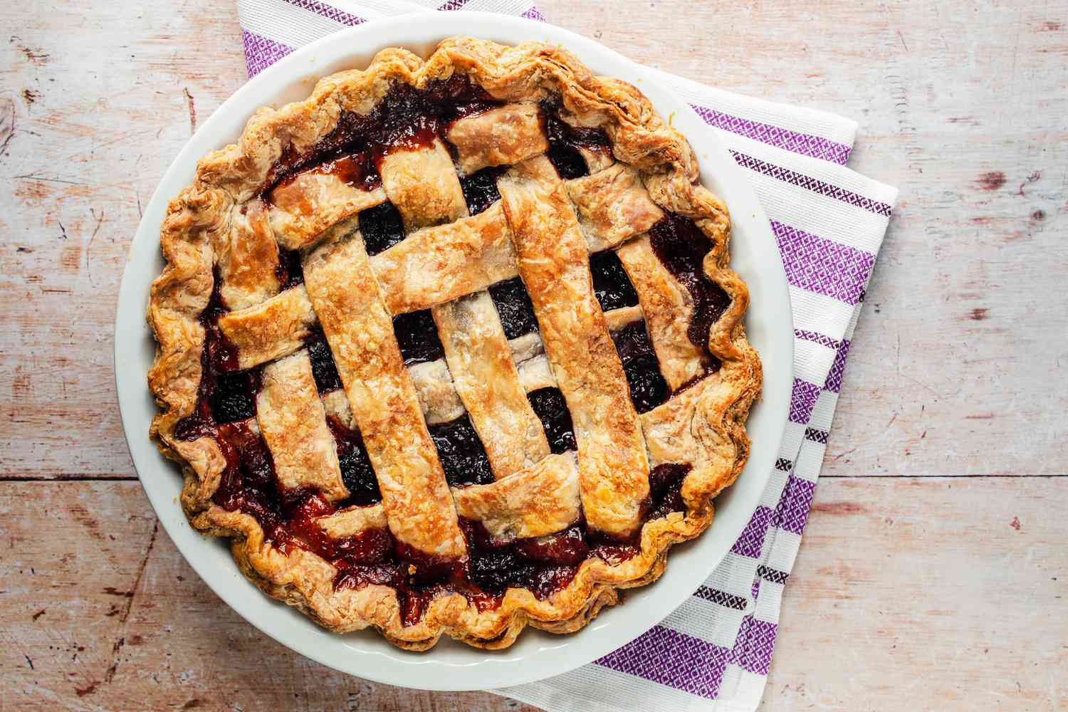 Blackberry Pie in a Pie Dish Sitting on a Kitchen Towel