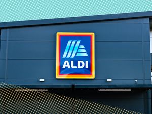 The exterior of an ALDI supermarket with the brand's logo prominently displayed on the facade