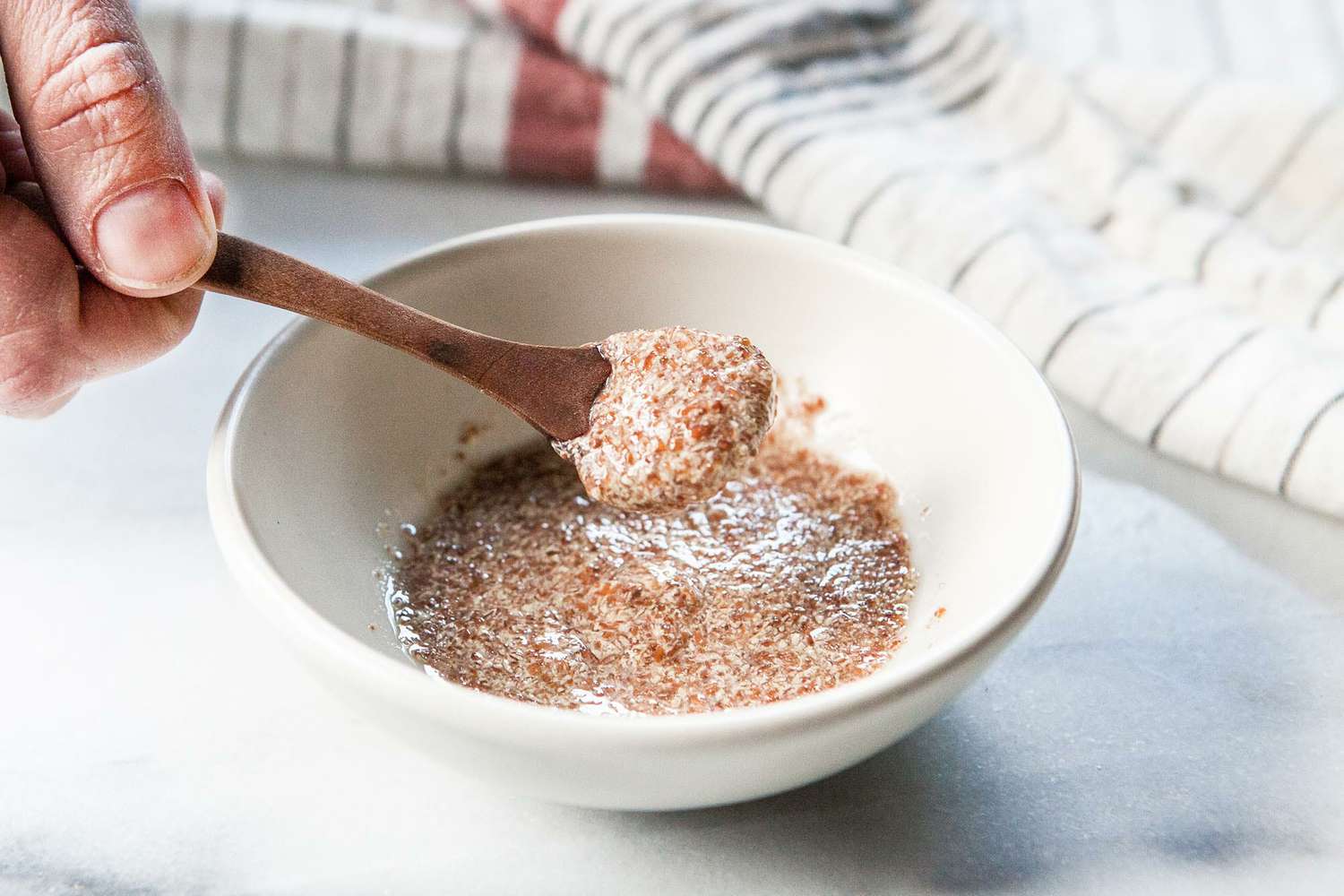 flax egg (flax and water) being mixed in a bowl