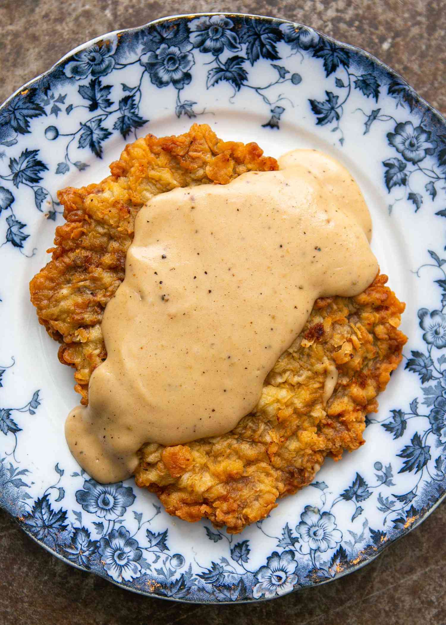 Homemade country fried steak with gravy on a plate