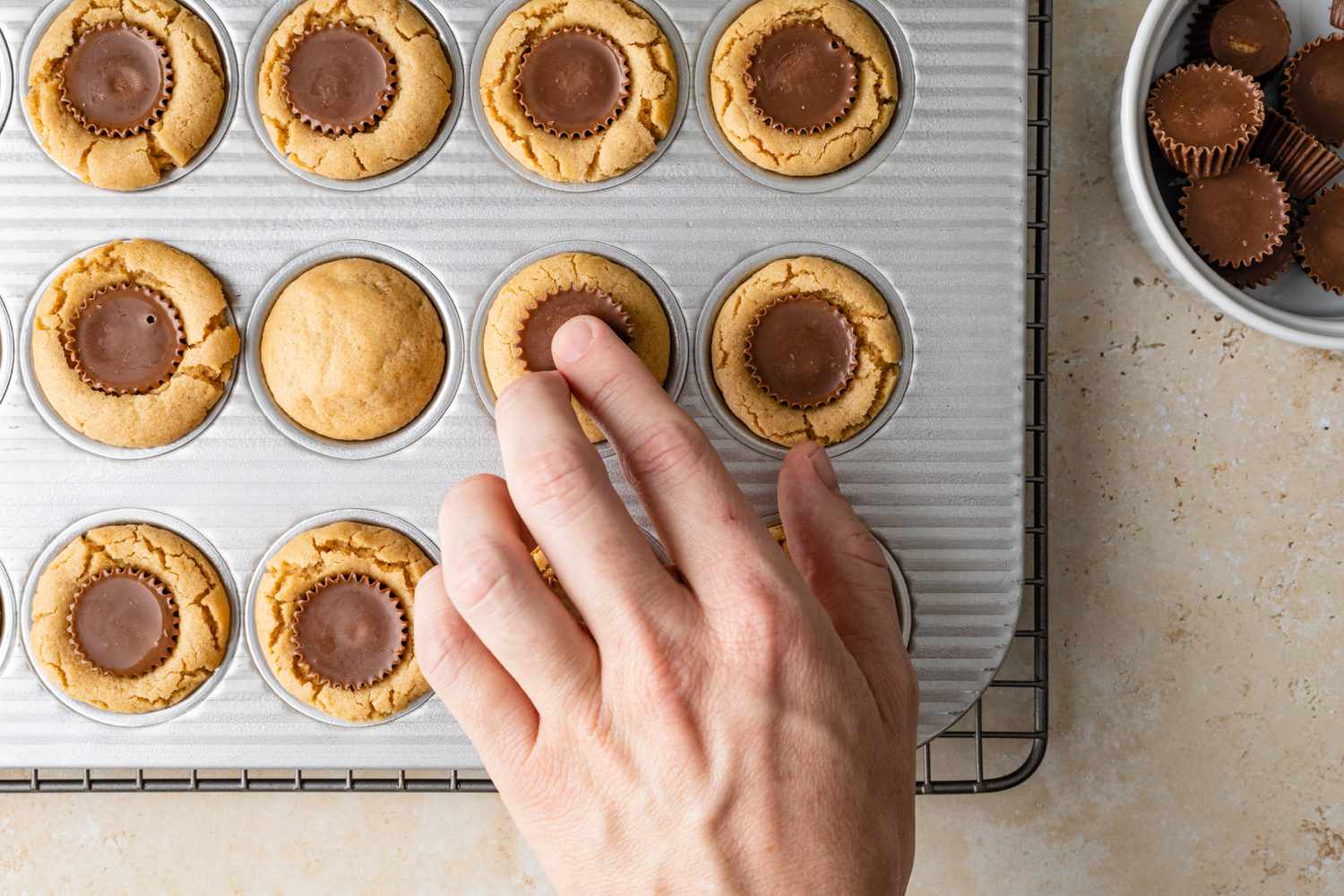 Peanut Butter Cup Pushed into Cookies Cooling on Baking Tray