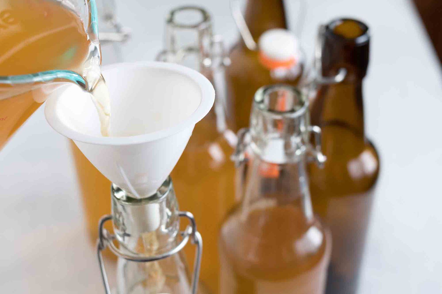 use a small funnel to pour the finished kombucha into swing top bottles