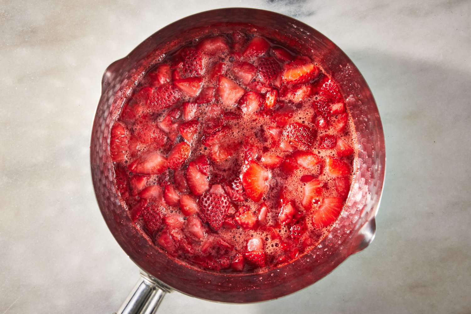 cooked strawberries in a pot for strawberry marlow recipe