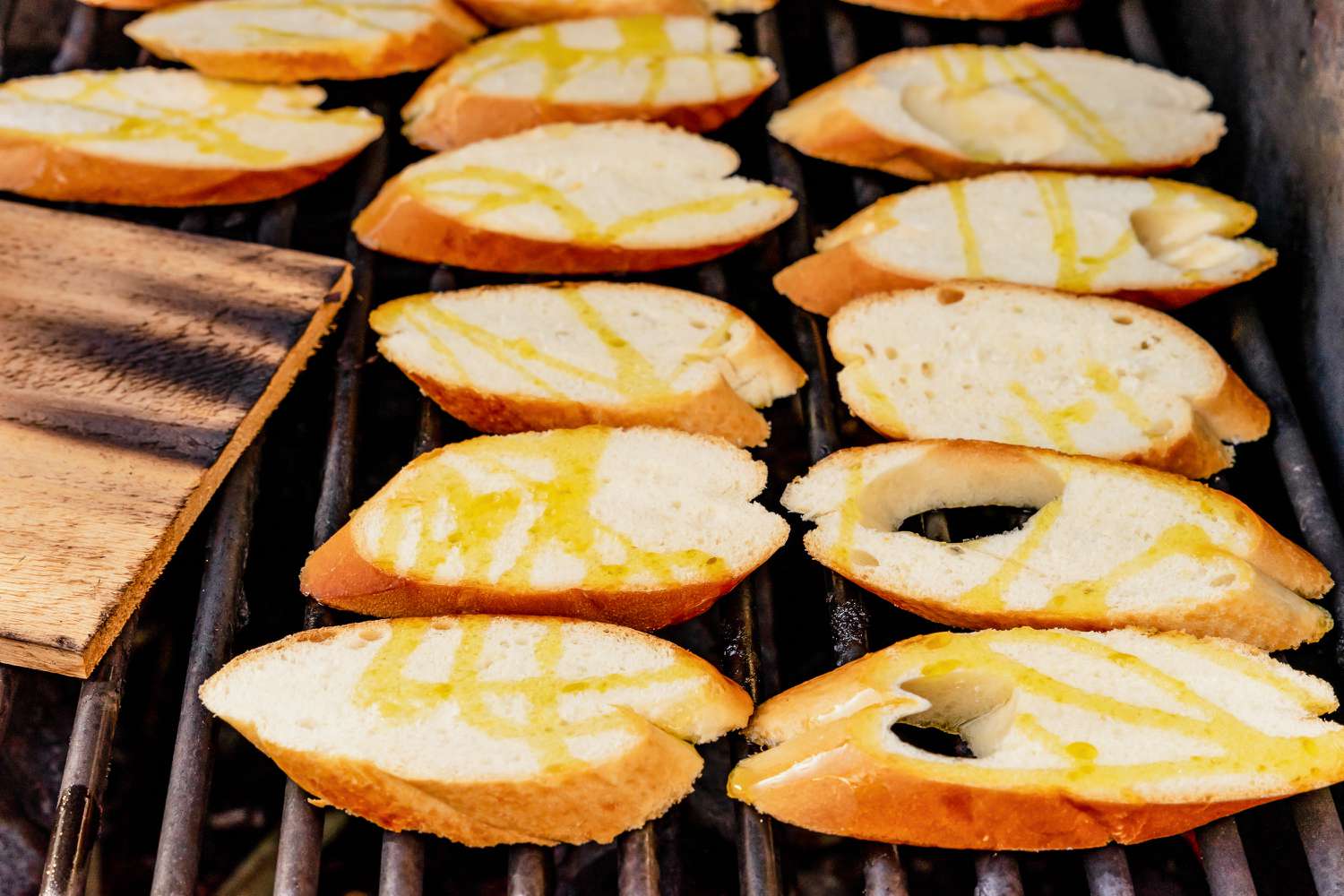 Sliced Baguette Added to Grill Next to Cedar Plank