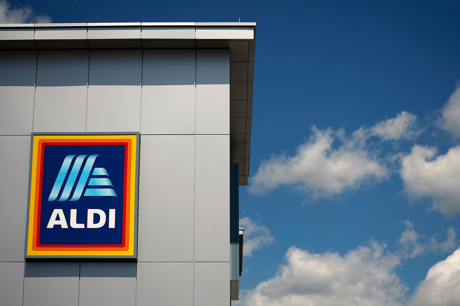 Aldi store with logo against a blue sky with clouds