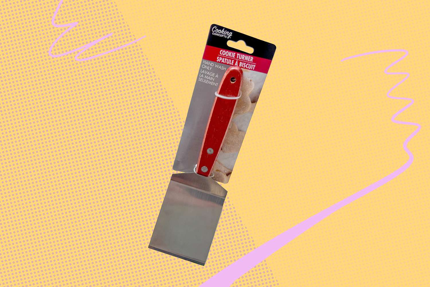 A cookie turner with a red handle in packaging displayed against a graphic background